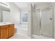 Bright bathroom featuring a soaking tub, glass shower, and wooden vanity at 4677 Creekside Cv, Atlanta, GA 30349