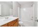 Bathroom with a light wood vanity, single sink, toilet, and shower-tub combo at 4677 Creekside Cv, Atlanta, GA 30349