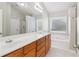 Primary bathroom features a double vanity, soaking tub, and natural light at 4677 Creekside Cv, Atlanta, GA 30349
