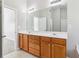 Primary bathroom features a large vanity with double sinks, and modern lighting at 4677 Creekside Cv, Atlanta, GA 30349