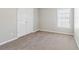 Neutral bedroom with gray carpet and a double door closet offers ample space at 4677 Creekside Cv, Atlanta, GA 30349