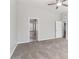 A spacious bedroom featuring a ceiling fan, neutral walls, and an en-suite bathroom at 4677 Creekside Cv, Atlanta, GA 30349