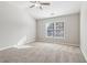 A view of a bright bedroom with a ceiling fan and a large window at 4677 Creekside Cv, Atlanta, GA 30349