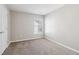 Cozy bedroom featuring a gray carpet, neutral walls, and natural light at 4677 Creekside Cv, Atlanta, GA 30349