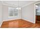 Bright dining room features hardwood floors, neutral paint, and decorative chandelier at 4677 Creekside Cv, Atlanta, GA 30349