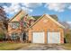 Charming brick two-story home featuring a two-car garage and well-maintained landscaping at 4677 Creekside Cv, Atlanta, GA 30349