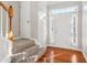 Bright entryway with hardwood floors, carpeted stairs, and natural light from sidelight windows at 4677 Creekside Cv, Atlanta, GA 30349