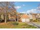 Charming brick front exterior with a two-car garage, complemented by a well-manicured lawn at 4677 Creekside Cv, Atlanta, GA 30349