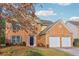Beautiful two-story brick home with a two-car garage and manicured front yard, exuding curb appeal at 4677 Creekside Cv, Atlanta, GA 30349