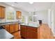 Bright kitchen transitions to living space with fireplace and features an island with lots of natural light at 4677 Creekside Cv, Atlanta, GA 30349