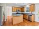 Well-equipped kitchen with wood cabinets, stainless steel appliances, and hardwood floors at 4677 Creekside Cv, Atlanta, GA 30349