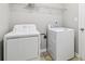 Convenient laundry room features washer, dryer, and a wire storage shelf at 4677 Creekside Cv, Atlanta, GA 30349