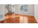 Neutral living room with hardwood floors, a large window, and staircase at 4677 Creekside Cv, Atlanta, GA 30349