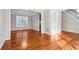 Open-concept living space with hardwood floors, neutral walls, and staircase access at 4677 Creekside Cv, Atlanta, GA 30349