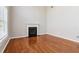 Spacious living room with hardwood floors, a fireplace, and large windows providing natural light at 4677 Creekside Cv, Atlanta, GA 30349