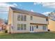 The rear exterior of the house has large windows and a door leading to a well-maintained yard at 4677 Creekside Cv, Atlanta, GA 30349