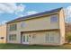 Back of home featuring large windows and a door to access the patio and yard at 4677 Creekside Cv, Atlanta, GA 30349
