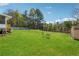 Large grassy backyard with mature trees and storage shed at 1532 Wethersfield Rd, Snellville, GA 30078