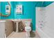 Cozy full bathroom featuring bright turquoise walls, a pedestal sink, and a shower and tub combo at 1532 Wethersfield Rd, Snellville, GA 30078