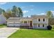 Charming home with two-car garage, inviting porch, and well-maintained front lawn at 1532 Wethersfield Rd, Snellville, GA 30078