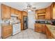 Bright kitchen with stainless steel appliances, wooden cabinets, and a tile backsplash at 1532 Wethersfield Rd, Snellville, GA 30078