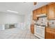 Cozy kitchen with light wood cabinets and a view of the stairway to the lower level at 1532 Wethersfield Rd, Snellville, GA 30078