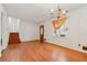 Living room featuring hardwood floors, stairs, a front door with stained glass window, and a chandelier at 1532 Wethersfield Rd, Snellville, GA 30078