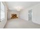 Bright living room with chandelier, stone fireplace, and natural light from the windows at 1532 Wethersfield Rd, Snellville, GA 30078
