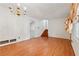 Open living room featuring wood floors, large window, and a chandelier at 1532 Wethersfield Rd, Snellville, GA 30078