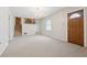Open-concept living room featuring an entry door, chandelier, and stairway to the second floor at 1532 Wethersfield Rd, Snellville, GA 30078