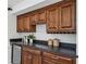 This bar area has dark wood cabinets, a dark countertop, a wine rack, and a mini fridge at 185 E Wesley Ne Rd, Atlanta, GA 30305