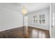 Spacious bedroom with hardwood floors and a large window fitted with shutter-style blinds, and a stylish globe pendant light at 185 E Wesley Ne Rd, Atlanta, GA 30305