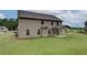 Wide backyard with a covered patio, and a lawn at 428 Hatcher Ct, Hampton, GA 30228