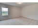 Bright bedroom with a single window and carpeted floor at 428 Hatcher Ct, Hampton, GA 30228