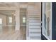 Inviting entryway featuring a staircase with wooden railings and modern, light-colored flooring at 428 Hatcher Ct, Hampton, GA 30228
