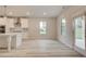 Bright and airy kitchen with white cabinets, stainless steel appliances, and modern pendant lighting at 428 Hatcher Ct, Hampton, GA 30228