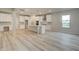 Bright, open kitchen with white cabinets, island, and modern appliances at 428 Hatcher Ct, Hampton, GA 30228