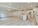 Open-concept living space with a modern kitchen, light wood flooring, and abundant natural light at 428 Hatcher Ct, Hampton, GA 30228