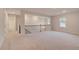 Upstairs loft area with neutral carpet, railing, and natural light at 428 Hatcher Ct, Hampton, GA 30228