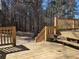 Wooden deck with stairs and seating overlooking a wooded backyard at 5685 Mccoy Nw Rd, Acworth, GA 30101