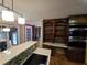 Gourmet kitchen featuring stainless steel appliances, quartz countertops, storage shelves and a peninsula island at 5685 Mccoy Nw Rd, Acworth, GA 30101