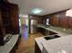 Fully-equipped kitchen has stainless steel appliances, quartz countertops, and stained wood cabinets at 5685 Mccoy Nw Rd, Acworth, GA 30101