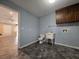 Small laundry room with linoleum flooring and a utility sink located off of additional living space at 5685 Mccoy Nw Rd, Acworth, GA 30101