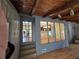 This living room has a wall of windows looking out to the kitchen and wood ceiling beams above at 5685 Mccoy Nw Rd, Acworth, GA 30101