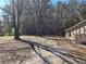 Expansive tree-lined yard and long driveway leading up to the charming home at 5685 Mccoy Nw Rd, Acworth, GA 30101