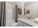 Neutral bathroom with a shower-tub combination, decorative shower curtain, and a single sink vanity at 141 Compass Rd, Hampton, GA 30228