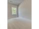 Bedroom featuring neutral paint, plush carpeting, a window, and white trim at 141 Compass Rd, Hampton, GA 30228