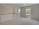 Neutral bedroom featuring plush carpeting, neutral paint, and natural light from the window at 141 Compass Rd, Hampton, GA 30228