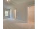 Bedroom featuring neutral paint and plush carpeting, with an entry to the walk-in closet at 141 Compass Rd, Hampton, GA 30228