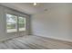 Cozy bedroom with plank floors, neutral paint, and a large window showcasing the outside view at 141 Compass Rd, Hampton, GA 30228
